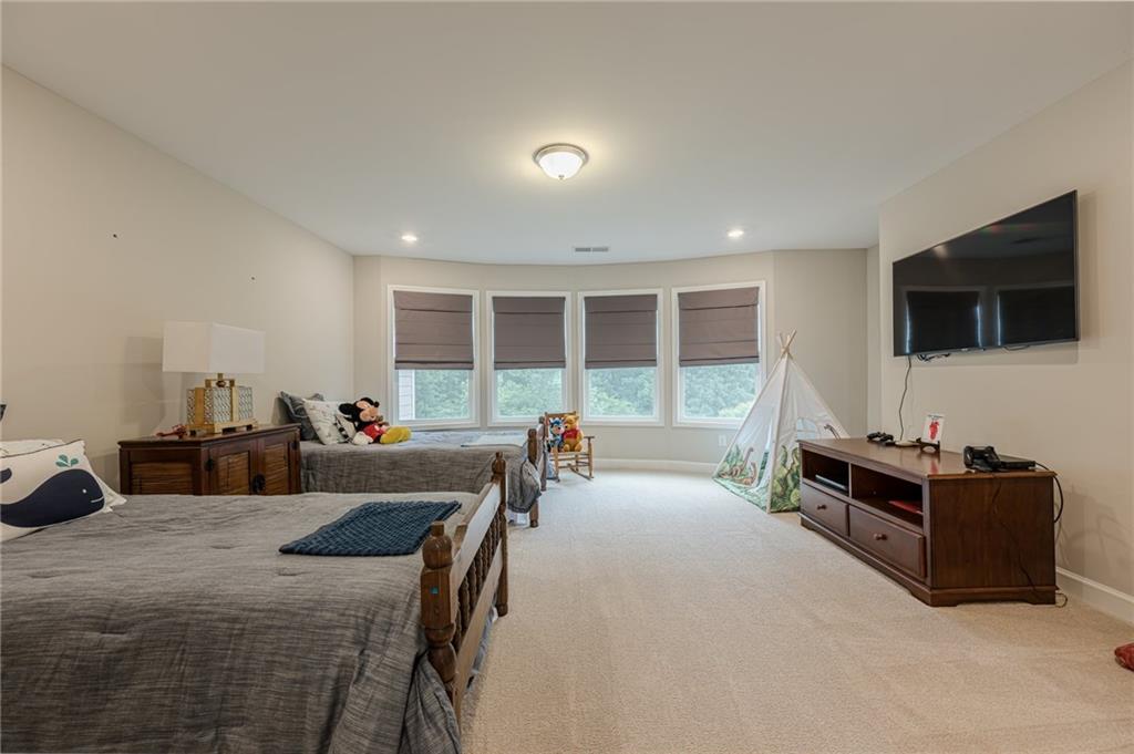 5515 Cheatam Avenue Cumming, GA 30040 - Photo 50 of 99 a living room with furniture and a flat screen tv