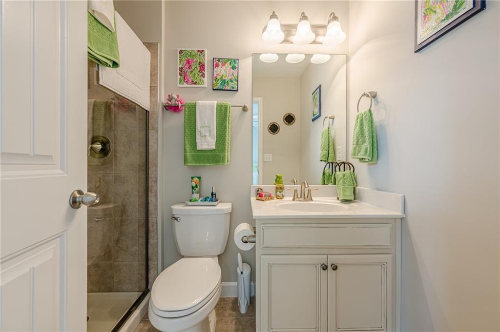5515 Cheatam Avenue Cumming, GA 30040 - Photo 60 of 99 a bathroom with a toilet a sink and a mirror