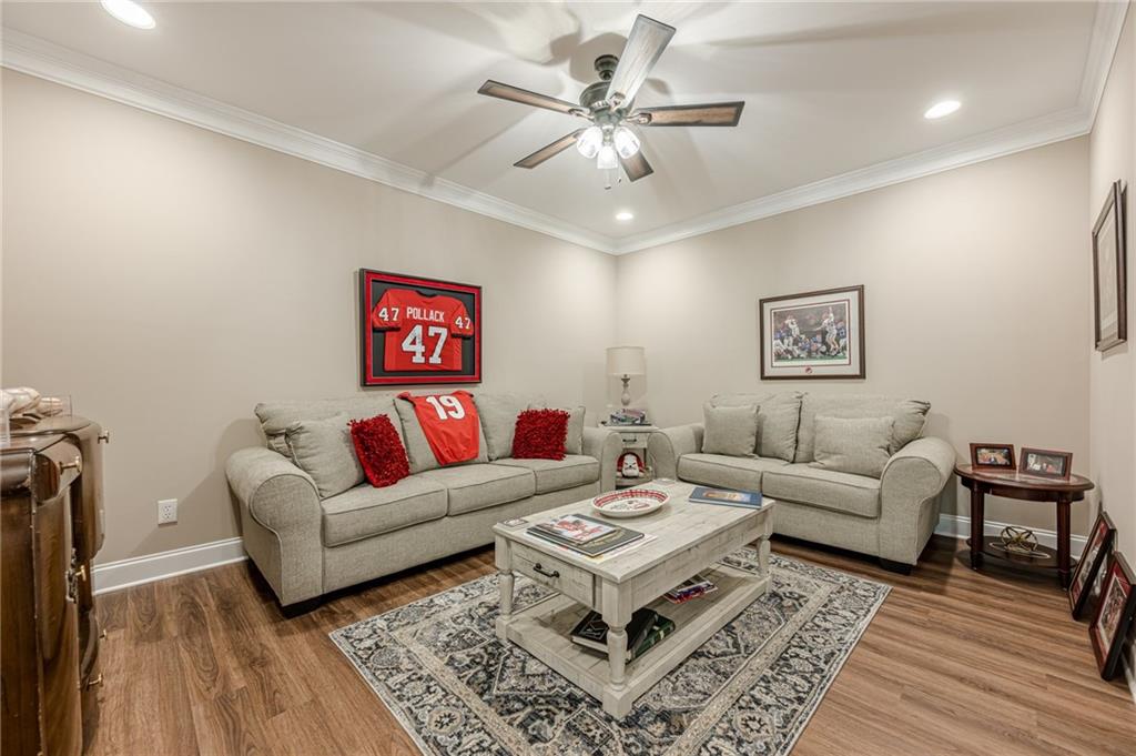 5515 Cheatam Avenue Cumming, GA 30040 - Photo 64 of 99 a living room with furniture a chandelier and a rug