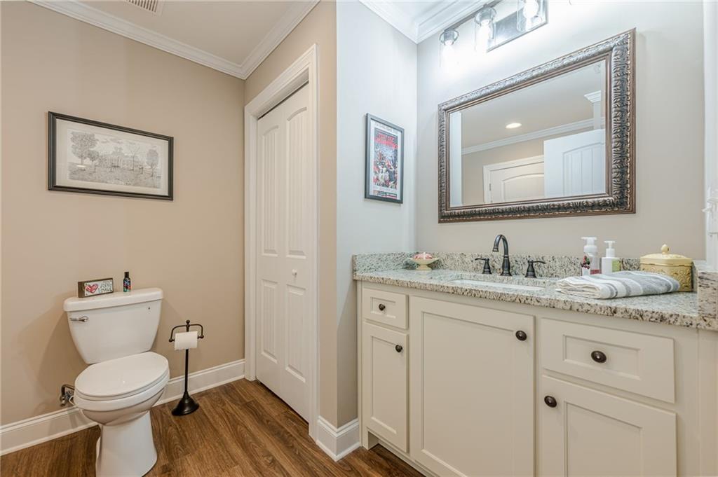 5515 Cheatam Avenue Cumming, GA 30040 - Photo 67 of 99 a bathroom with a granite countertop toilet sink and mirror