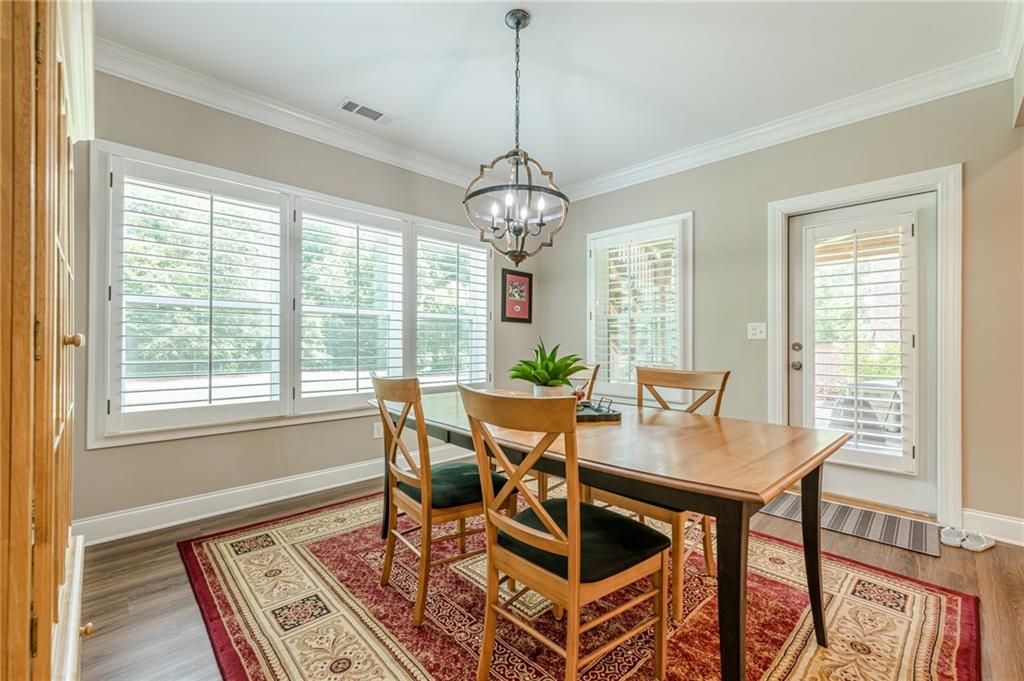 5515 Cheatam Avenue Cumming, GA 30040 - Photo 73 of 99 a view of a dining room with furniture window and wooden floor