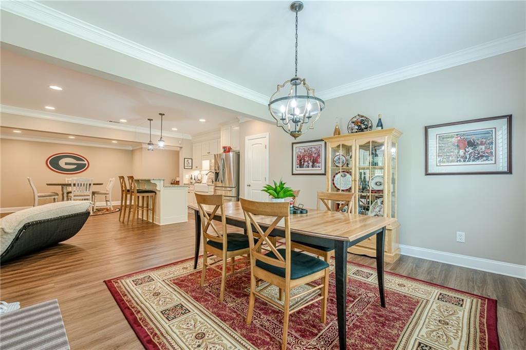 5515 Cheatam Avenue Cumming, GA 30040 - Photo 75 of 99 a view of a dining room with furniture wooden floor and chandelier