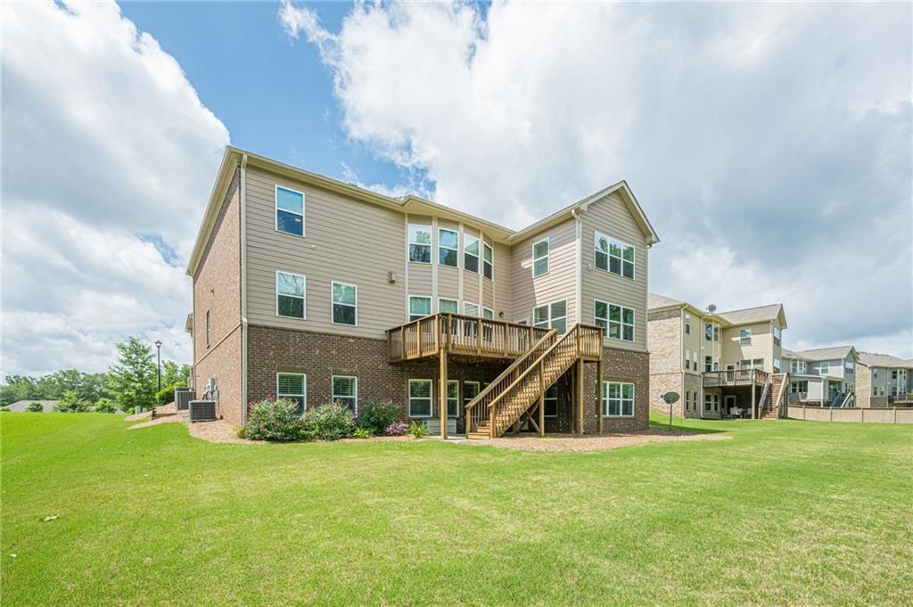5515 Cheatam Avenue Cumming, GA 30040 - Photo 91 of 99 a view of a big house with a big yard and large trees