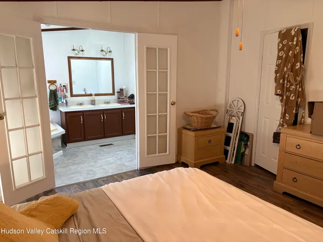 a bedroom with a bed and dresser