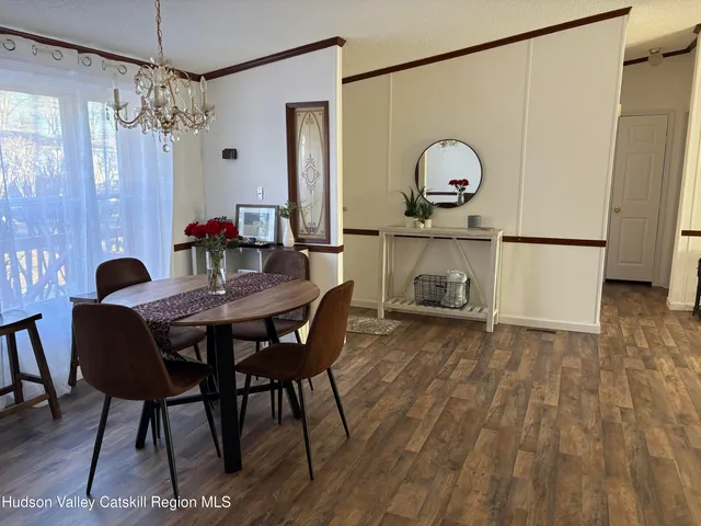 a view of a dining room with furniture and chandelier