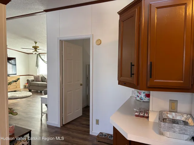 a kitchen with a sink and wooden floor