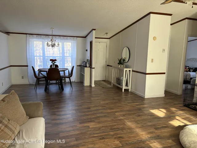a living room with fireplace furniture and a wooden floor