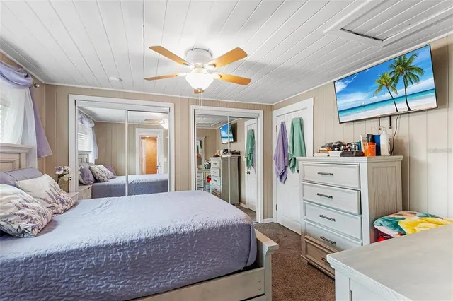 a bedroom with a bed and ceiling fan