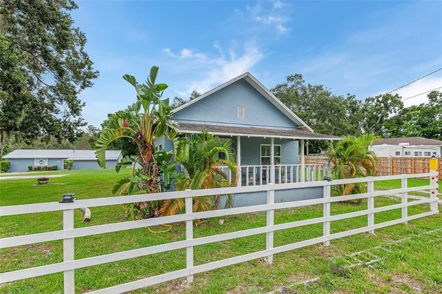 a view of a house with a yard and plants