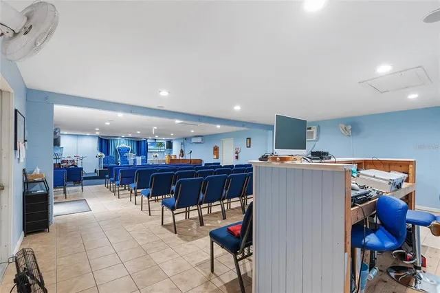a living room with furniture and a dining table with kitchen view