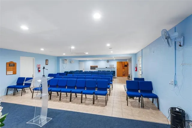 a living room with furniture and a dining table with wooden floor