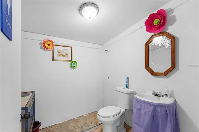 a bathroom with a sink mirror vanity and toilet