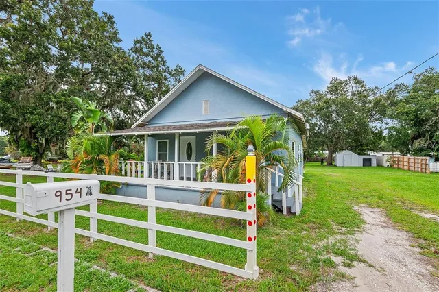 a front view of a house with a yard table and chairs