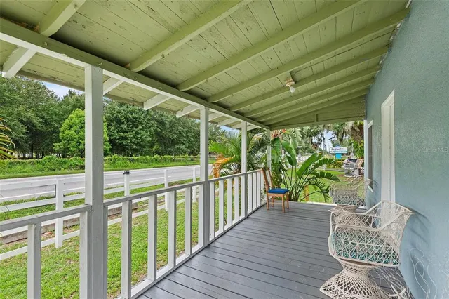 a view of a porch with wooden floor