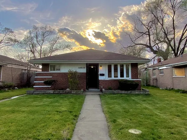 a view of a house with a yard and sitting area