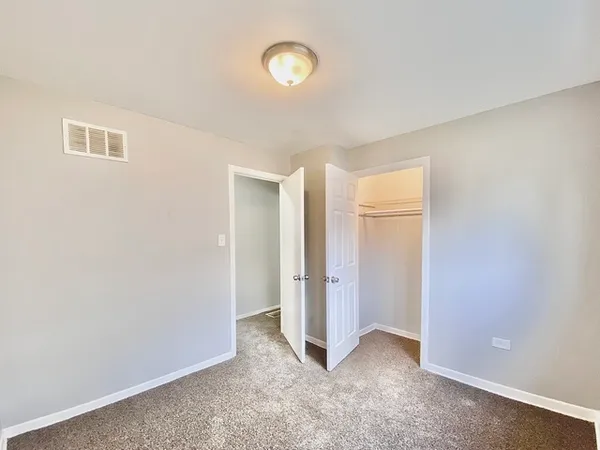 an empty room with closet area