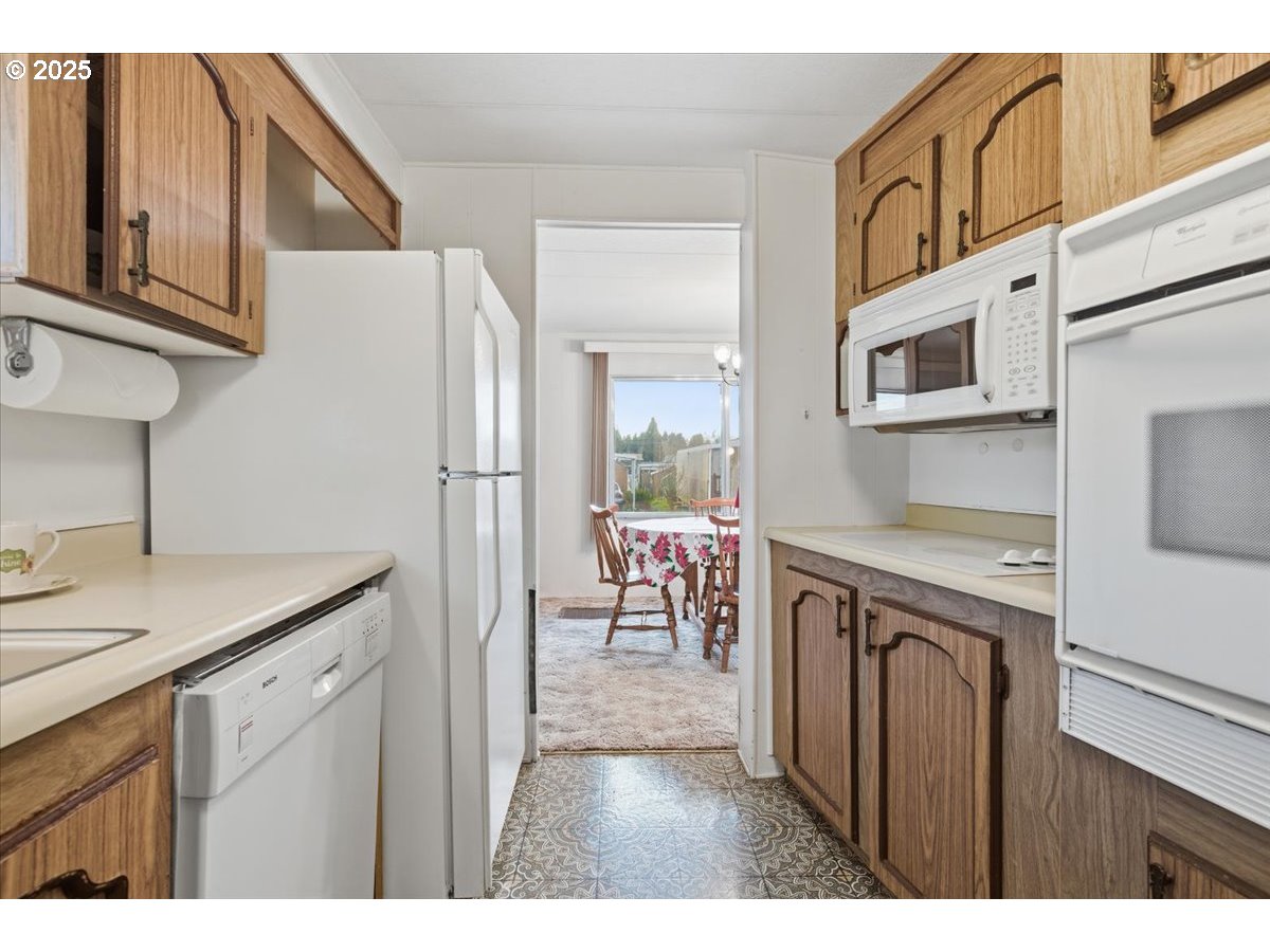 4940 Sunnyside Road Southeast, Unit H5 Salem, OR 97302 - Photo 12 of 35 front view of a kitchen with a sink and a refrigerator