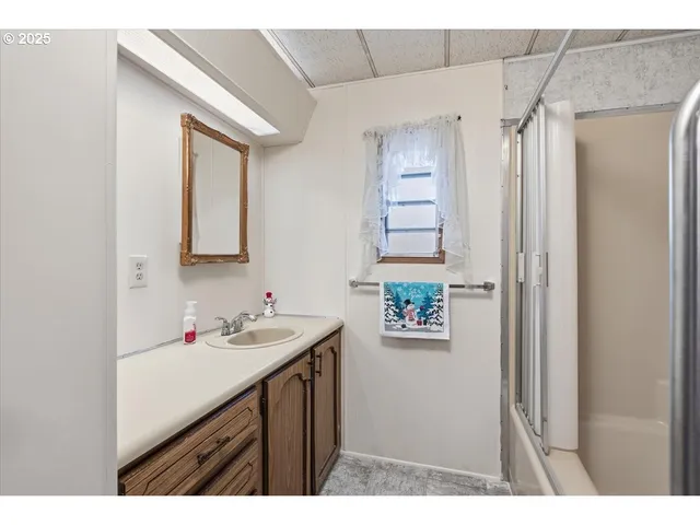 a bathroom with a shower and a glass door