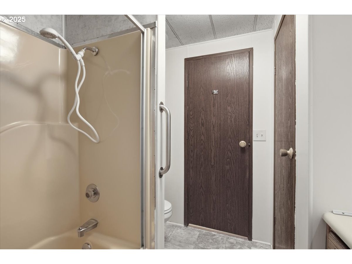 4940 Sunnyside Road Southeast, Unit H5 Salem, OR 97302 - Photo 25 of 35 a bathroom with a shower and a glass door