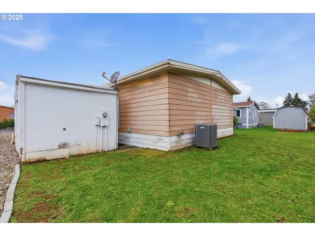 a backyard of a house with table and chairs