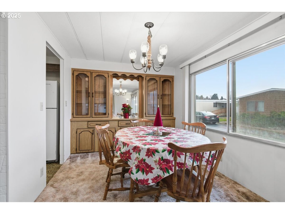 4940 Sunnyside Road Southeast, Unit H5 Salem, OR 97302 - Photo 7 of 35 a view of a dining room with furniture window and outside view