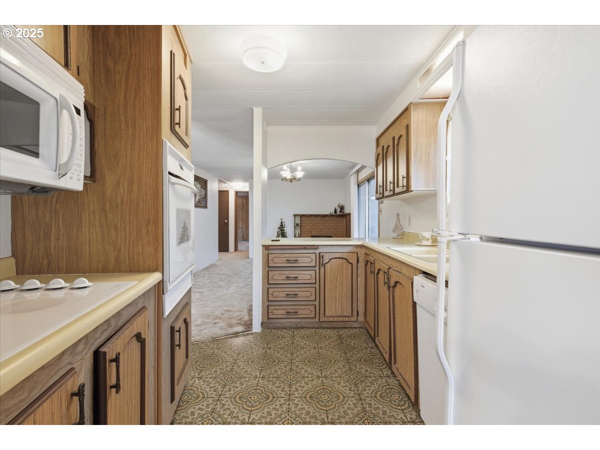 4940 Sunnyside Road Southeast, Unit H5 Salem, OR 97302 - Photo 10 of 35 a kitchen that has a lot of white cabinets and stainless steel appliances