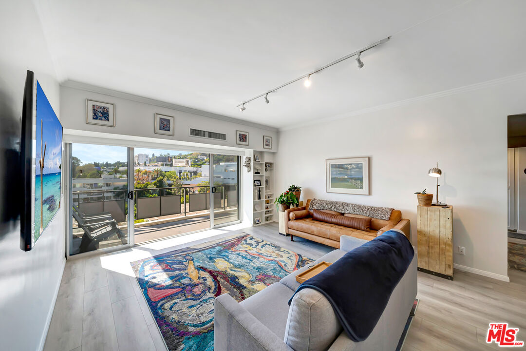 a living room with furniture and a floor to ceiling window