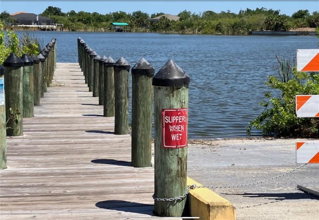 13232 Kitchener Avenue Port Charlotte, FL 33981 - Photo 2 of 5 a sign board with a lake view