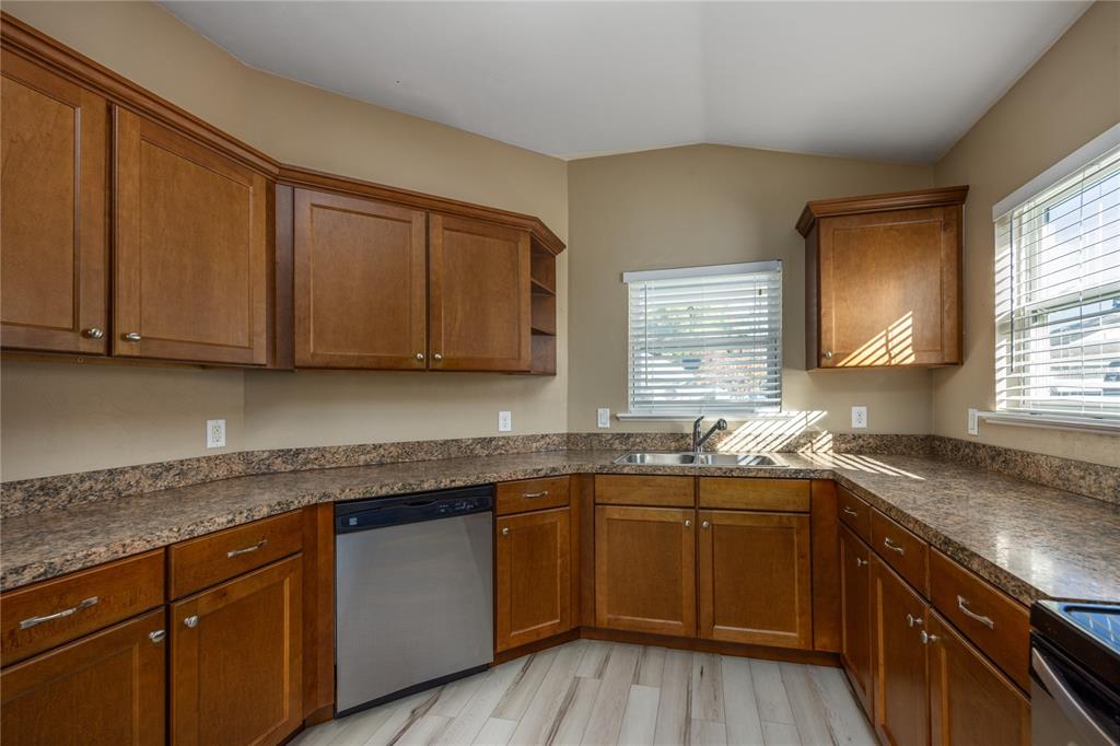 470 Southwest 251st Street Newberry, FL 32669 - Photo 11 of 33 a kitchen with stainless steel appliances granite countertop wooden cabinets a sink and dishwasher with wooden floor