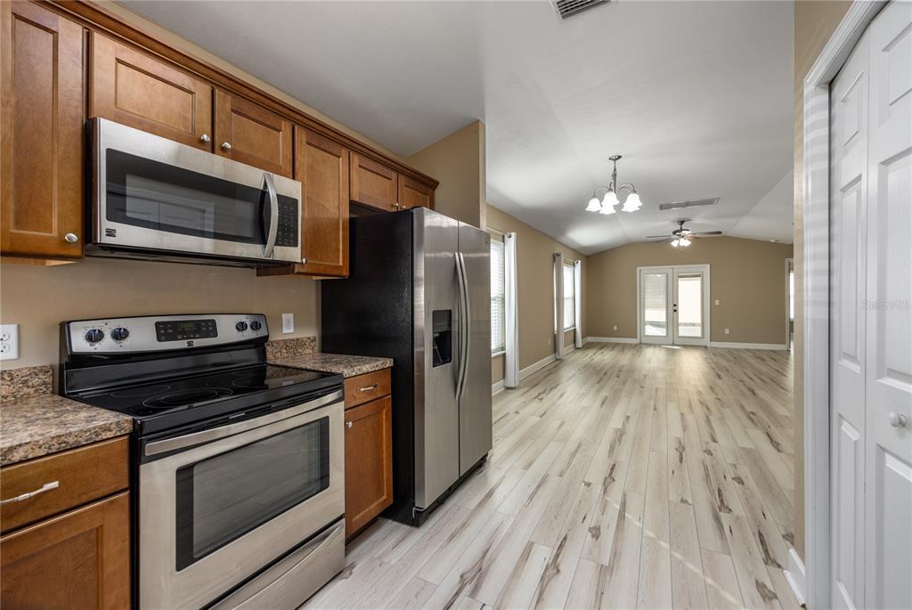470 Southwest 251st Street Newberry, FL 32669 - Photo 13 of 33 a kitchen with stainless steel appliances a stove microwave and sink