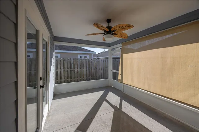 a view of hallway with a ceiling fan