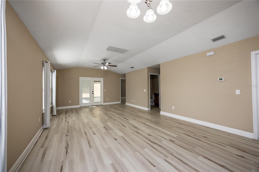 470 Southwest 251st Street Newberry, FL 32669 - Photo 7 of 33 a view of an empty room with wooden floor and a window