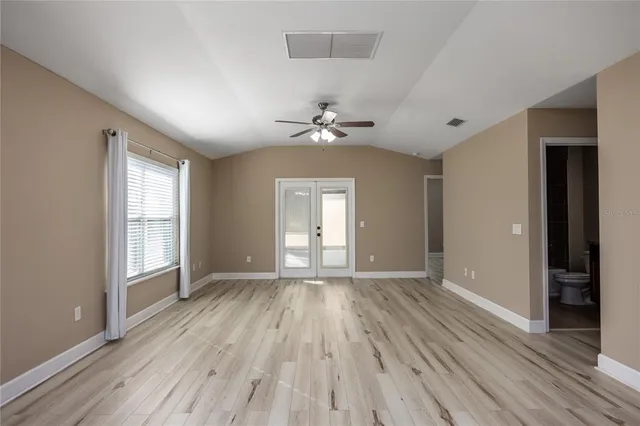 wooden floor in an empty room with a window
