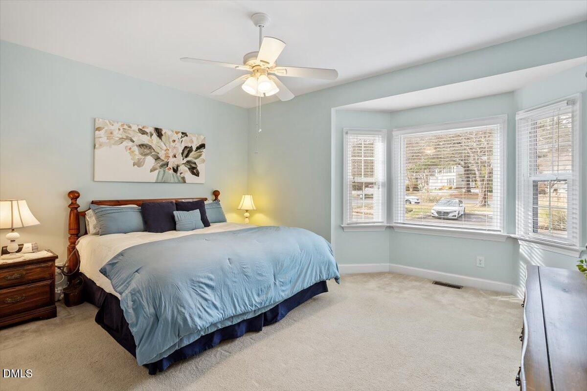 126 Skylark Way Raleigh, NC 27615 - Photo 17 of 29 a bedroom with a large bed and a chandelier