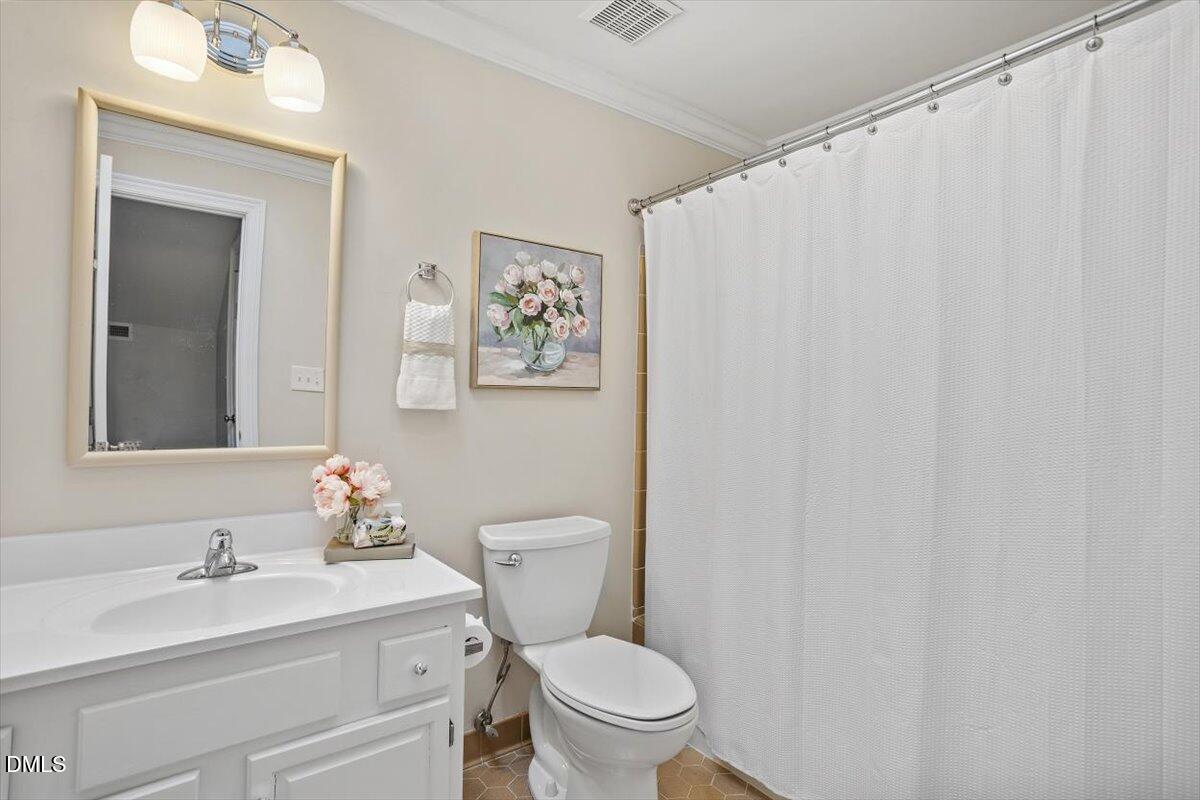 126 Skylark Way Raleigh, NC 27615 - Photo 26 of 29 a bathroom with a toilet a sink and a mirror