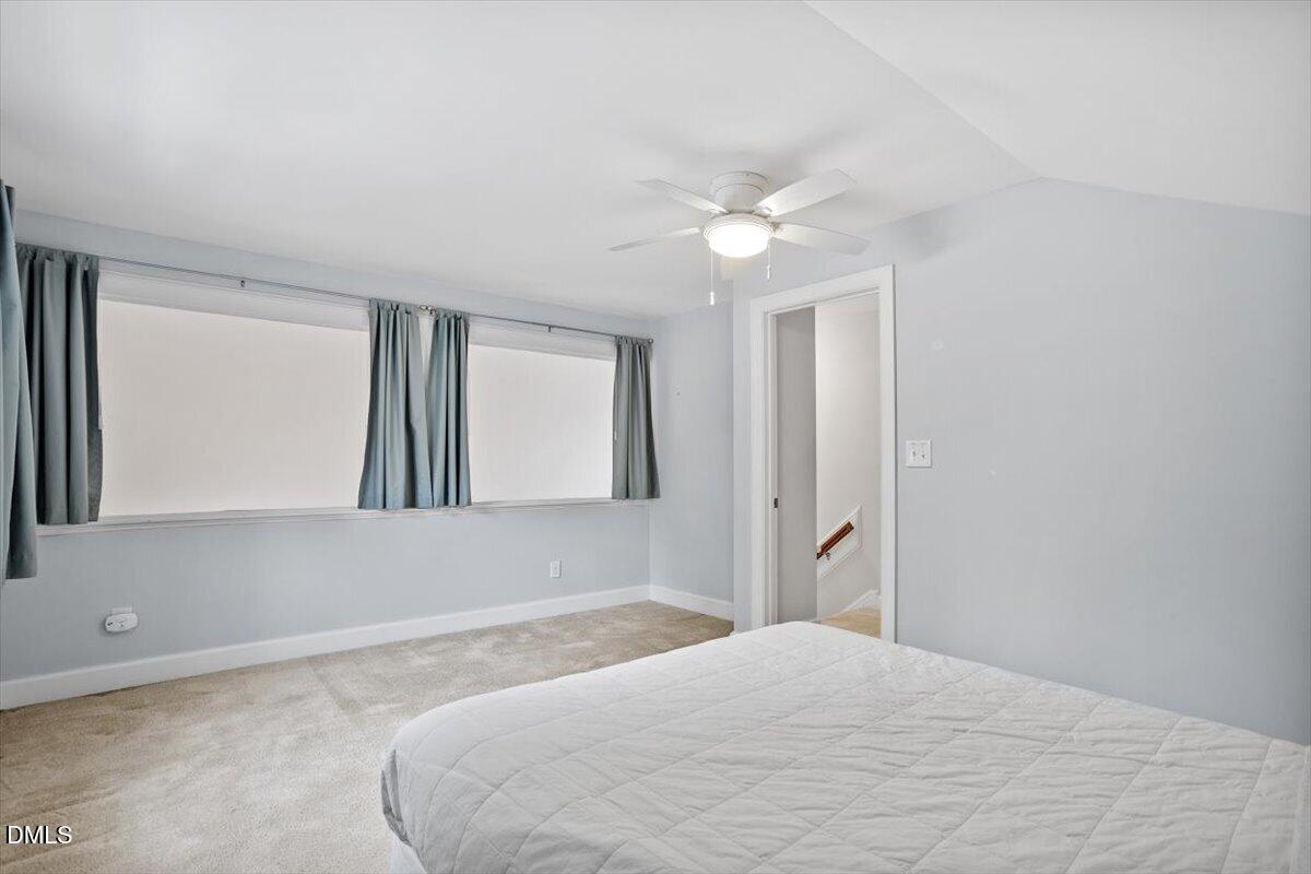 126 Skylark Way Raleigh, NC 27615 - Photo 28 of 29 a bedroom with a large bed and chandelier fan