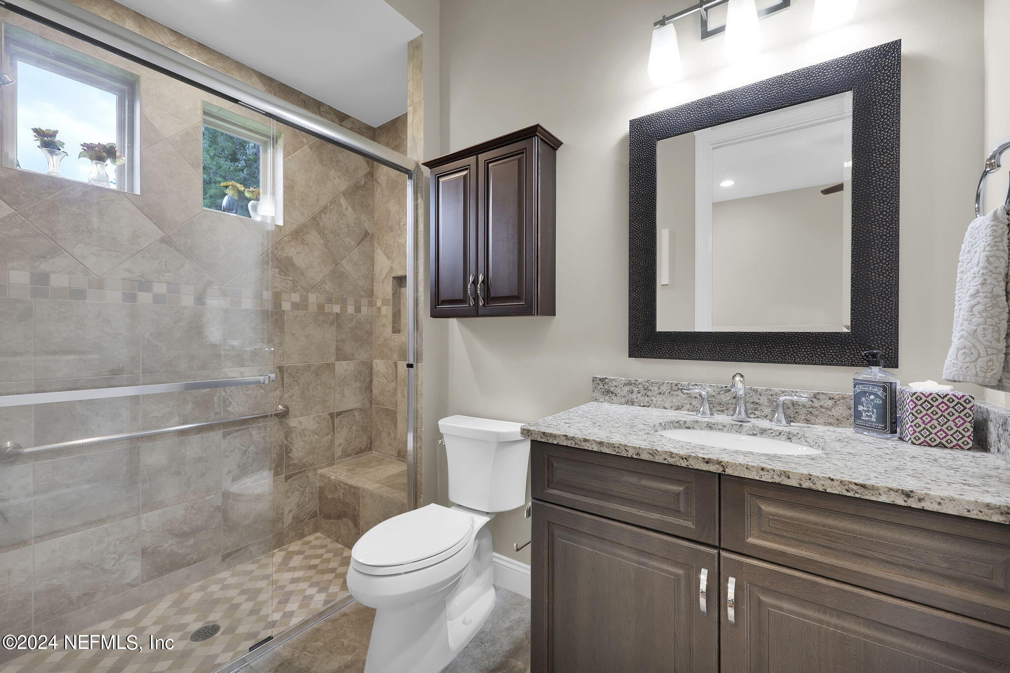 125 Senora Court St. Augustine, FL 32095 - Photo 49 of 109 a bathroom with a granite countertop toilet sink and mirror