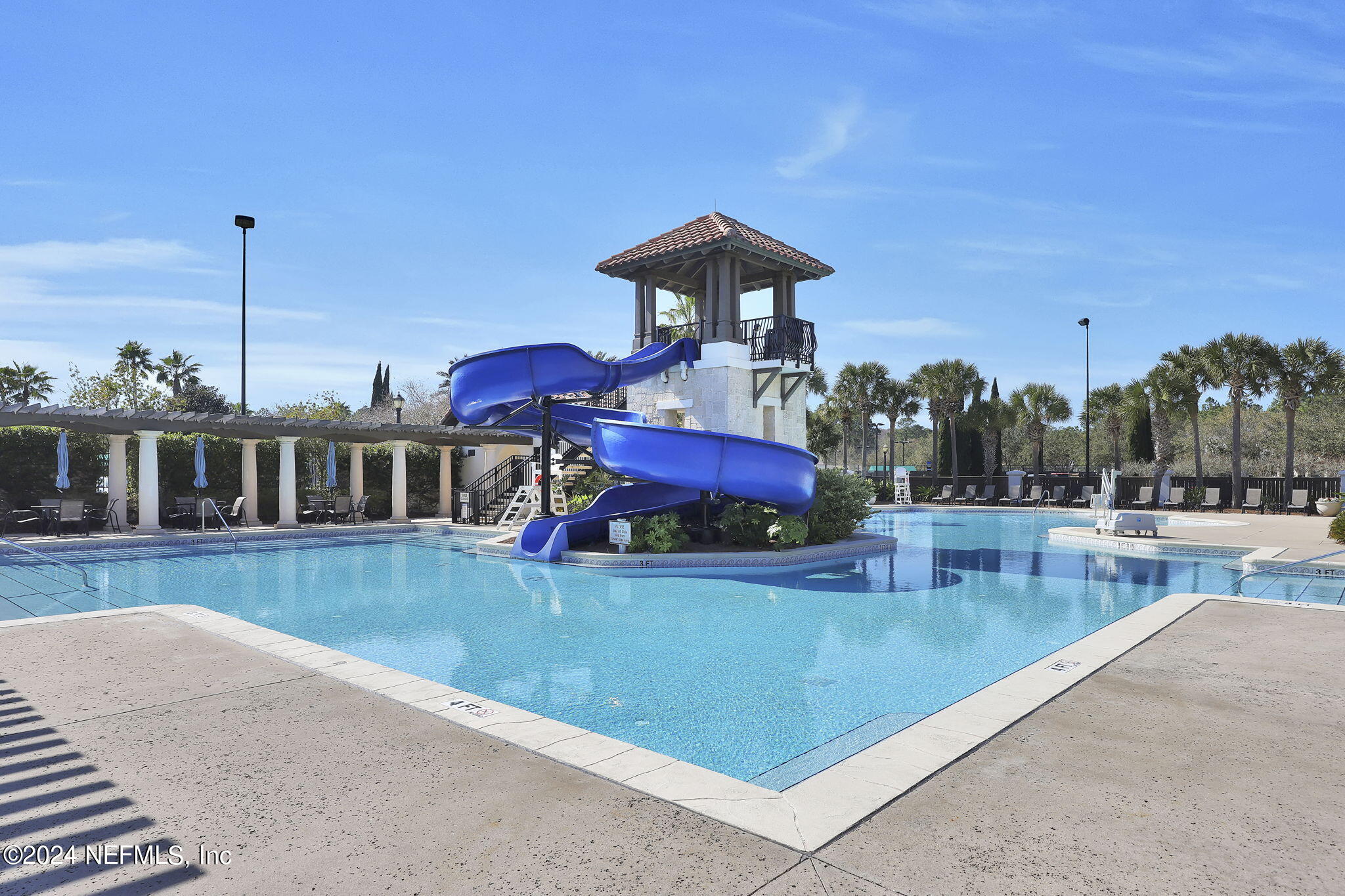 125 Senora Court St. Augustine, FL 32095 - Photo 88 of 109 a view of a swimming pool with a table and chairs
