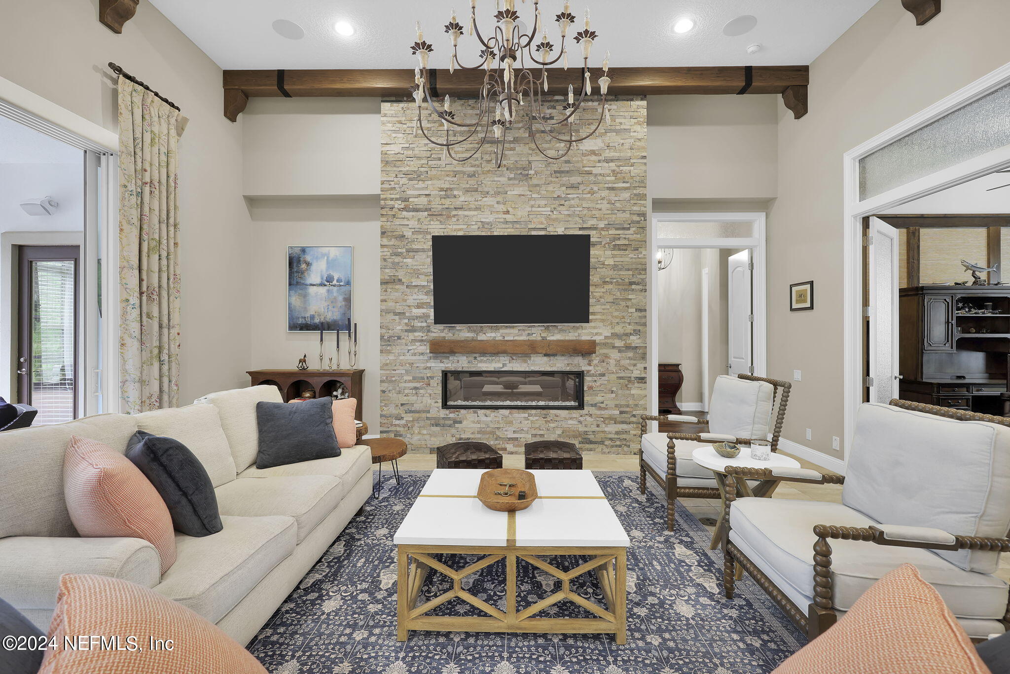 125 Senora Court St. Augustine, FL 32095 - Photo 9 of 109 a living room with furniture a fireplace and a flat screen tv