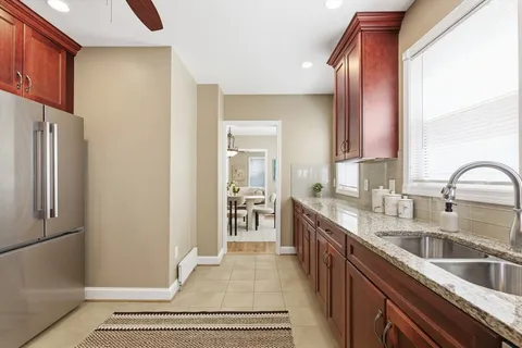 a kitchen with stainless steel appliances granite countertop a refrigerator and a sink