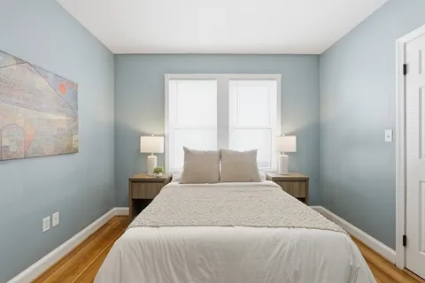 a bedroom with a bed and window
