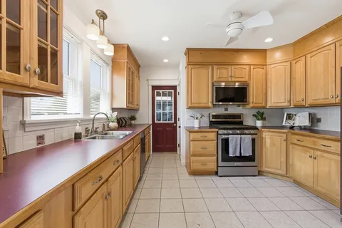 a kitchen with stainless steel appliances granite countertop a sink and a stove