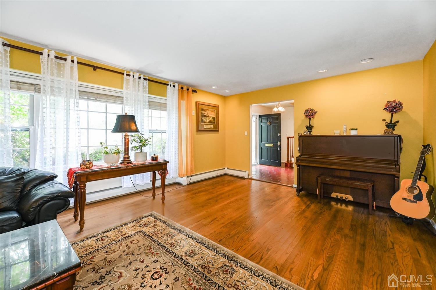 50 Clive Hills Road Edison, NJ 08820 - Photo 11 of 32 a living room with furniture and a wooden floor