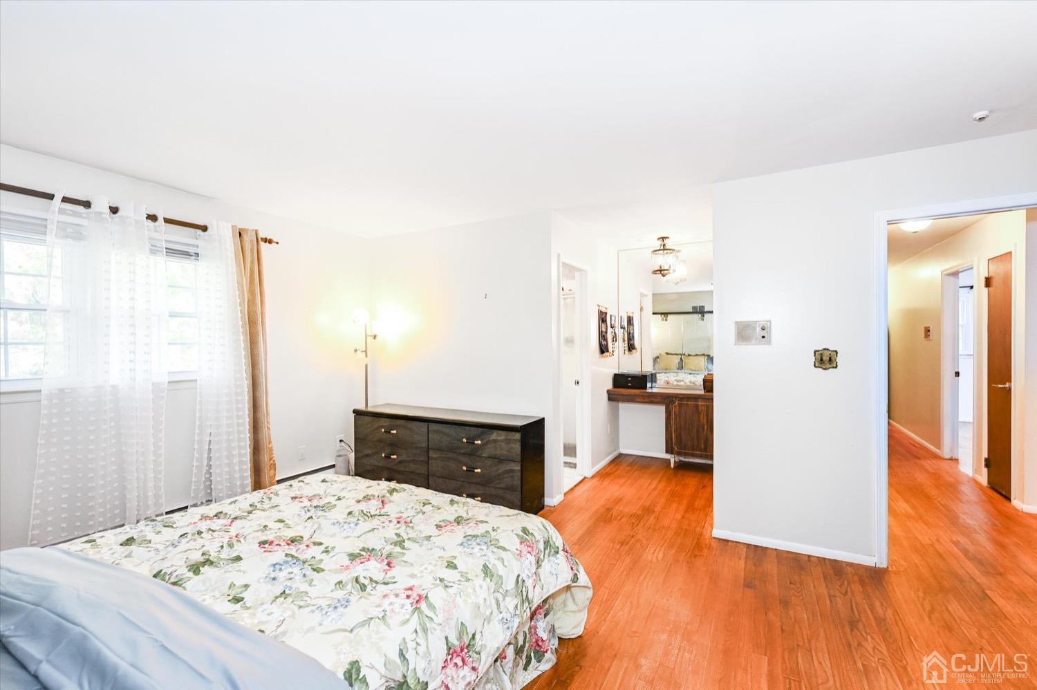 50 Clive Hills Road Edison, NJ 08820 - Photo 19 of 32 a bedroom with a bed and wooden floor