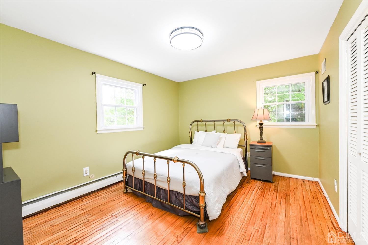 50 Clive Hills Road Edison, NJ 08820 - Photo 21 of 32 a bedroom with a bed and wooden floor