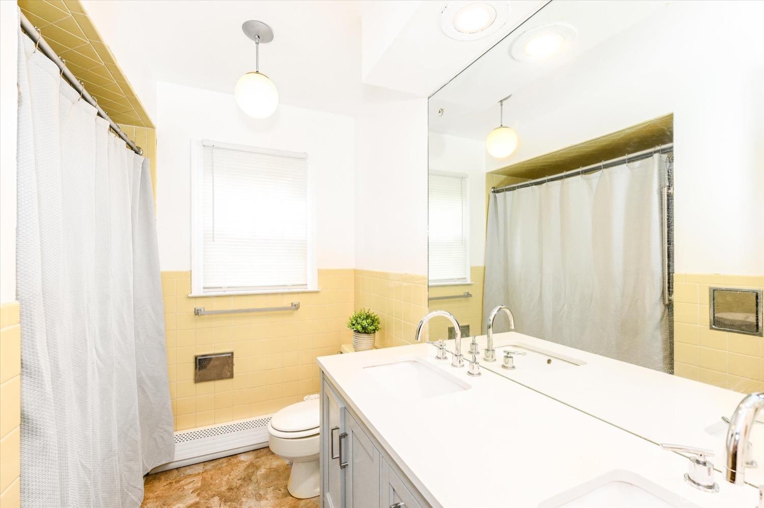 50 Clive Hills Road Edison, NJ 08820 - Photo 24 of 32 a bathroom with a sink a toilet and shower curtain