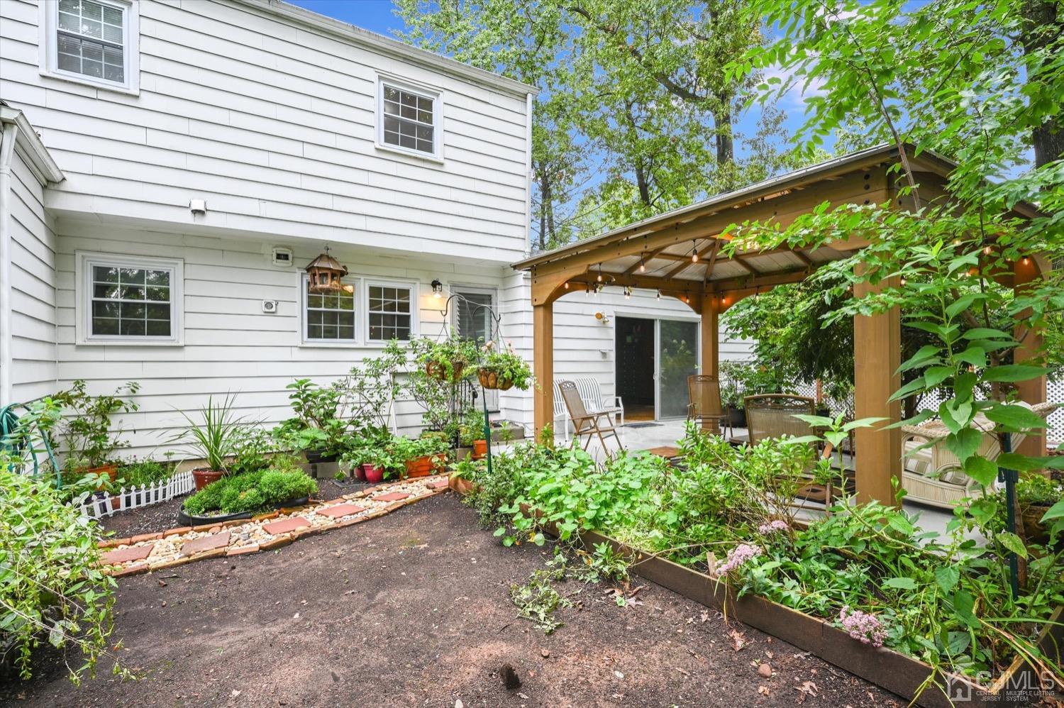 50 Clive Hills Road Edison, NJ 08820 - Photo 28 of 32 a view of a house with a yard and plants