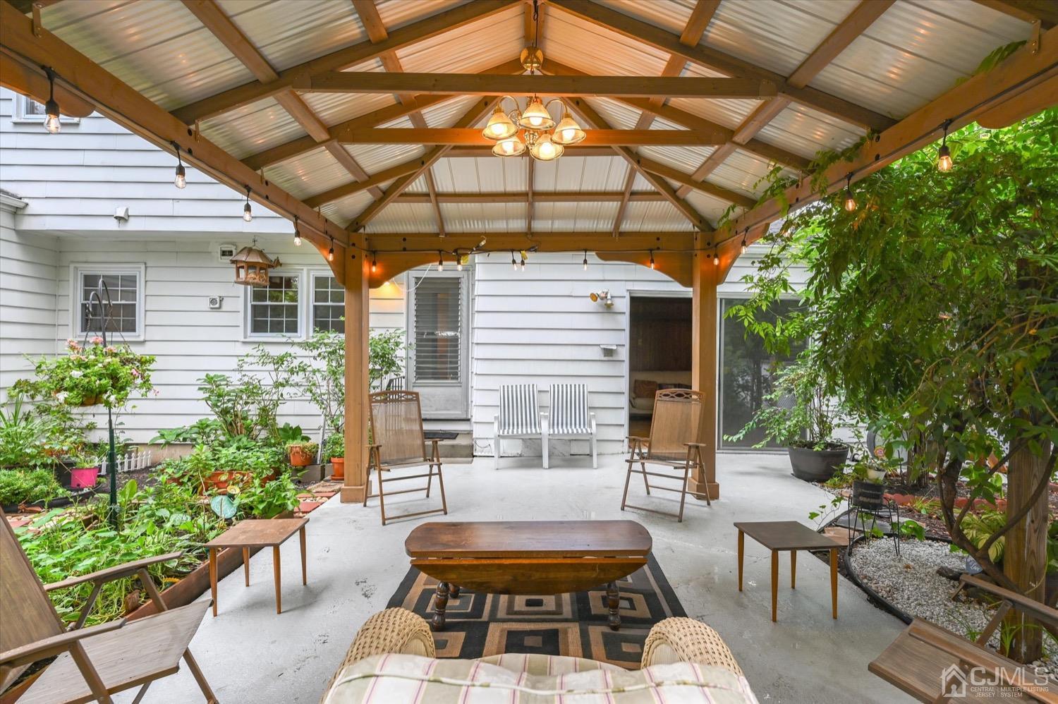 50 Clive Hills Road Edison, NJ 08820 - Photo 4 of 32 a view of a patio with couches table and chairs and potted plants