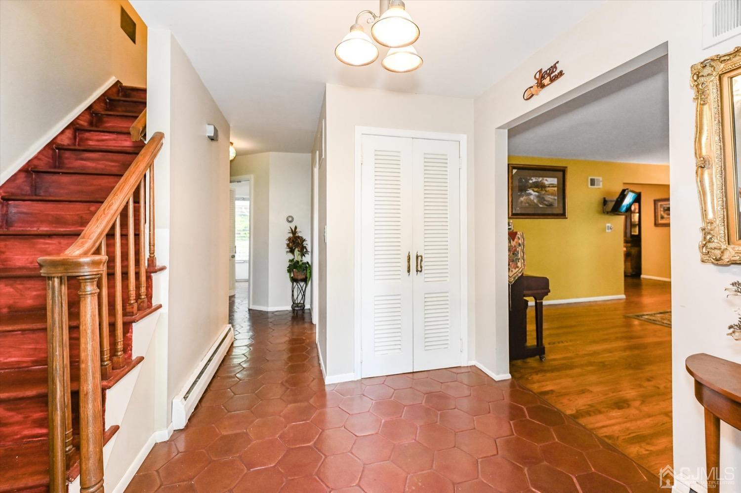 50 Clive Hills Road Edison, NJ 08820 - Photo 7 of 32 a view of a hallway with wooden floor and staircase