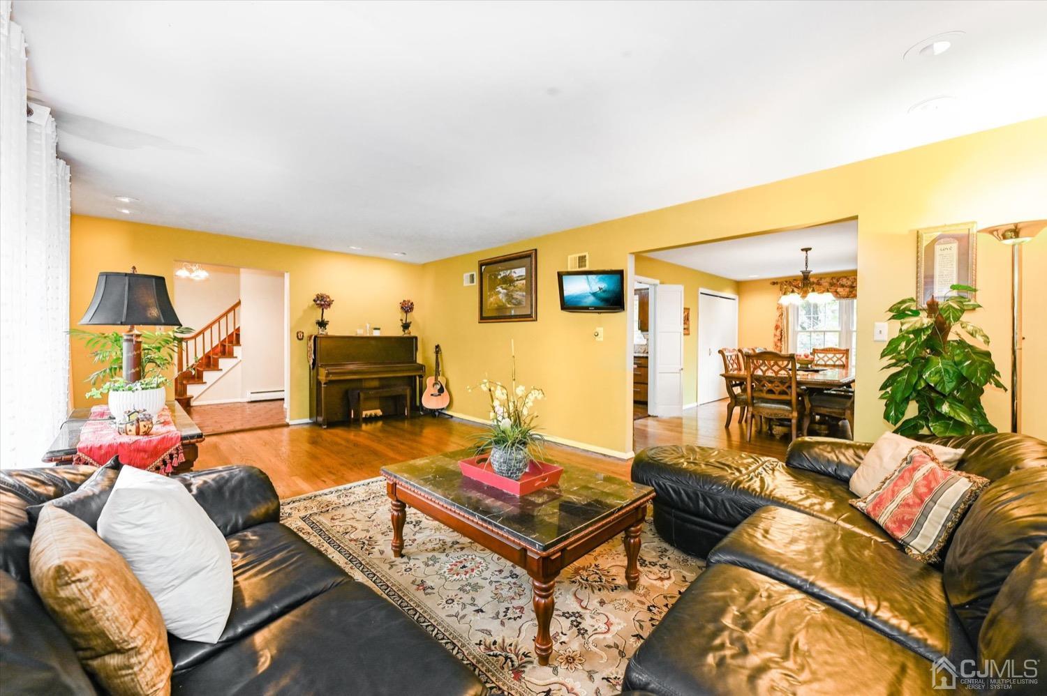 50 Clive Hills Road Edison, NJ 08820 - Photo 10 of 32 a living room with furniture and a flat screen tv